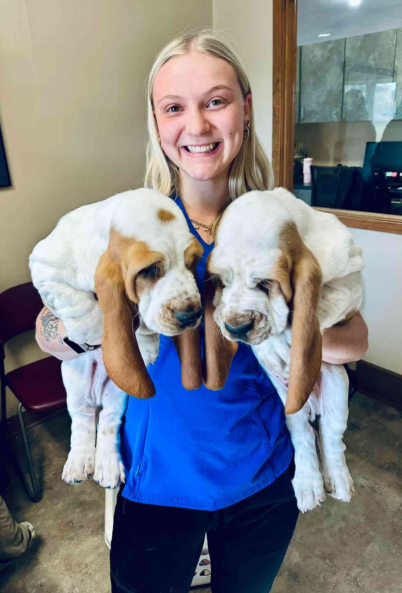 woman holding two puppies